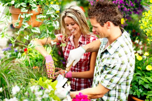 Illustration of a gardener handing an information leaflet to a visitor with accessibility icons.